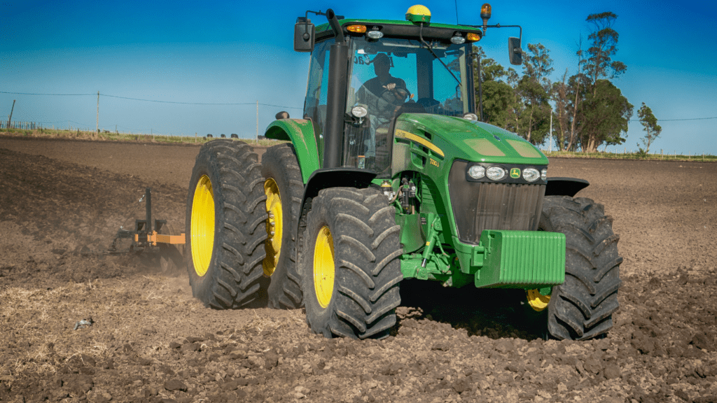 an tractor sits in the middle of a field