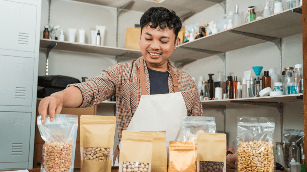 a person is standing in front of a table with bags of food