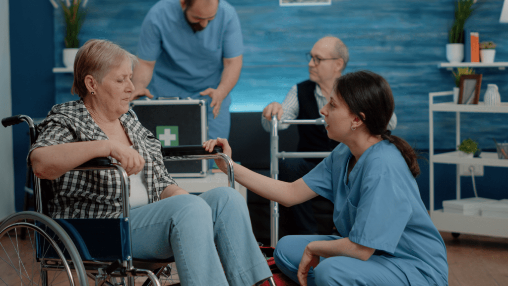 A person in a wheelchair being helped by a nurse