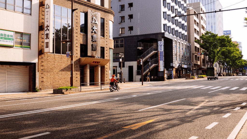 a person riding a bike down an empty street