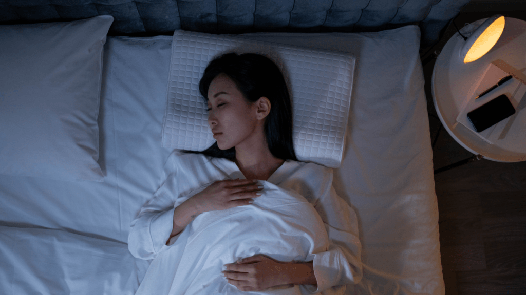 A person sleeping in bed at night