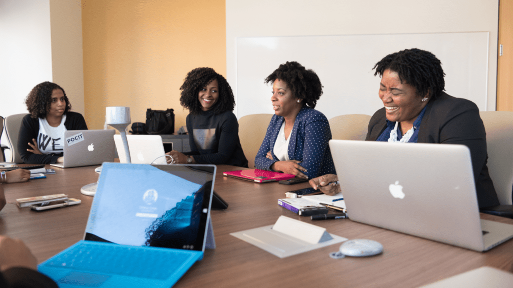 a group of people working on a laptop