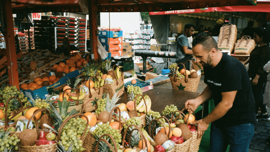 an outdoor market with lots of fruit and vegetables